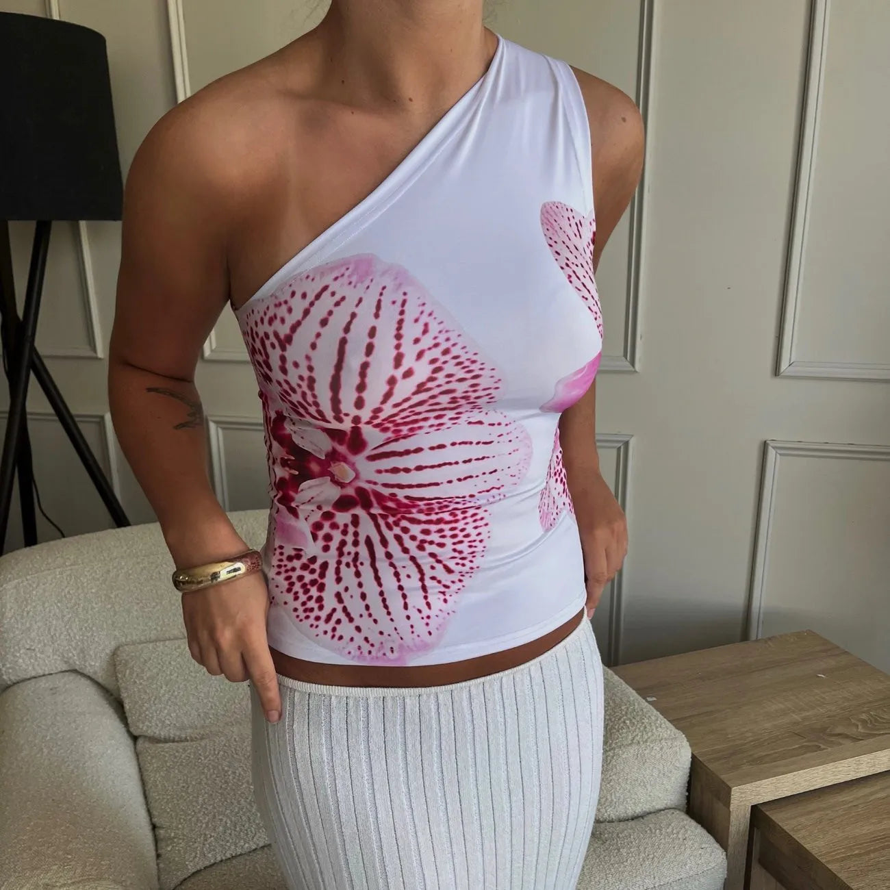 Elevate your summer style with the Gaono Floral Print Fitted Top! This chic one-shoulder tank features a vibrant floral design, perfect for resort wear or casual outings. Made from a soft, breathable cotton-polyester blend, it offers comfort