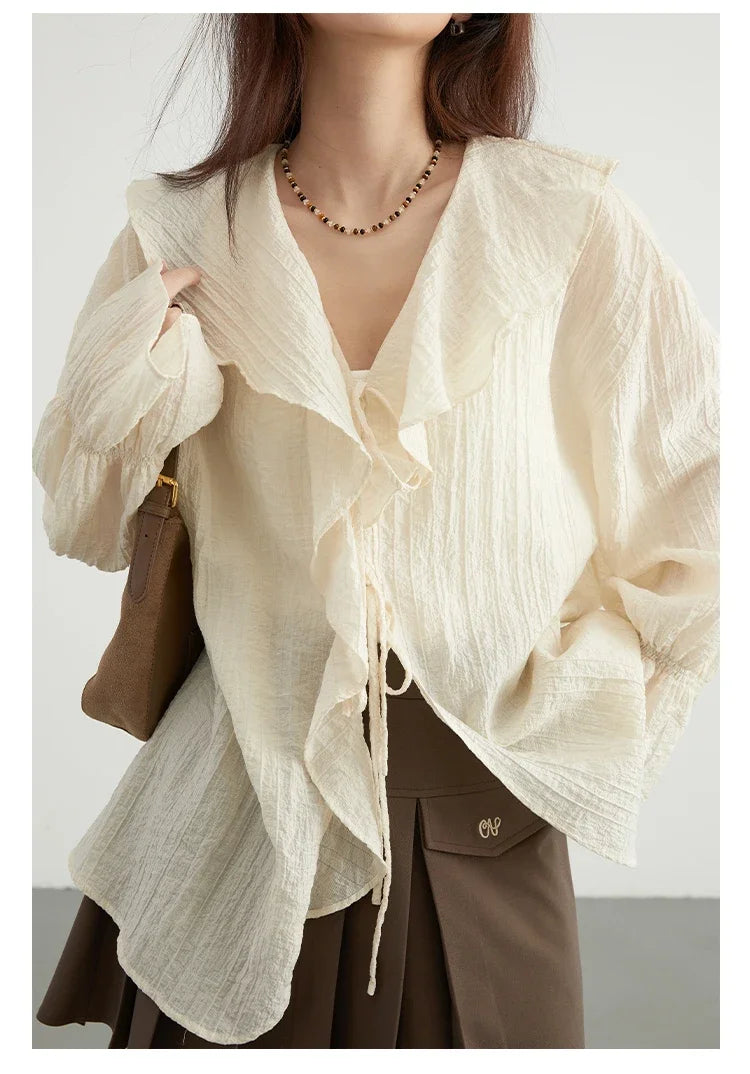 Effortlessly chic Ruffled V-Neck Lace-Up Blouse, perfect for spring and summer. This stylish top features a beautiful ruffled neckline, playful lace-up detailing for an adjustable fit, and a loose fit design for maximum comfort. Available in