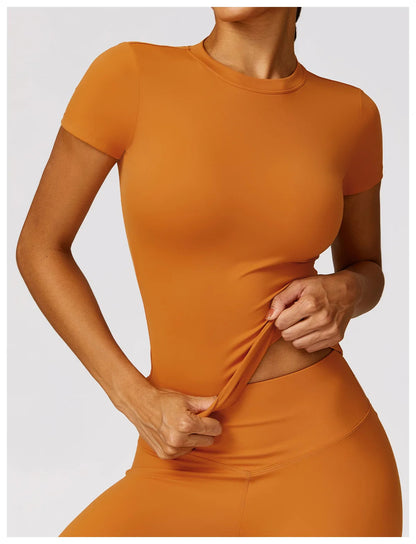 Elevate your activewear collection with the NCLAGEN Short Sleeve T-Shirt, designed for both performance and style. This lightweight, breathable top features a fitted silhouette and round neck, ensuring comfort during workouts, yoga sessions, or casual outings. Available in