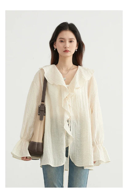Effortlessly chic Ruffled V-Neck Lace-Up Blouse, perfect for spring and summer. Featuring a beautiful ruffled neckline, adjustable lace-up detailing, and a loose fit for ultimate comfort. Available in versatile colors, this blouse seamlessly transitions from