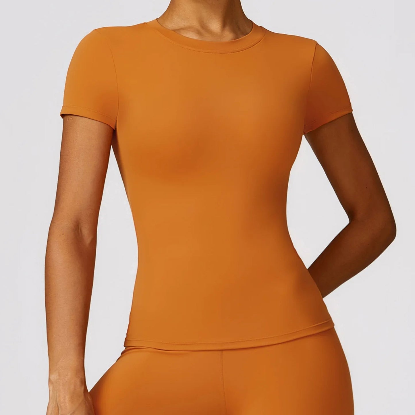 Elevate your fitness wardrobe with the NCLAGEN Short Sleeve T-Shirt, crafted from lightweight and breathable nylon for ultimate comfort. This stylish gym wear features a round neck and fitted silhouette, ensuring a flattering fit for any body type. Perfect for workouts,