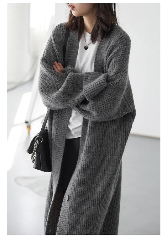 Effortlessly stylish Korean Loose Knitted Cardigan & Long Coat, crafted from luxuriously soft knitted fabric for ultimate comfort. This oversized fit offers a cozy silhouette that flatters every figure, making it perfect for layering. Featuring a timeless button closure