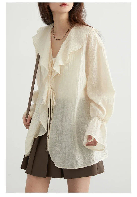 Effortlessly chic Ruffled V-Neck Lace-Up Blouse in a versatile color, designed for the modern woman. This stylish blouse features a beautiful ruffled neckline and playful lace-up detailing, ensuring an adjustable fit. The loose fit provides breathability